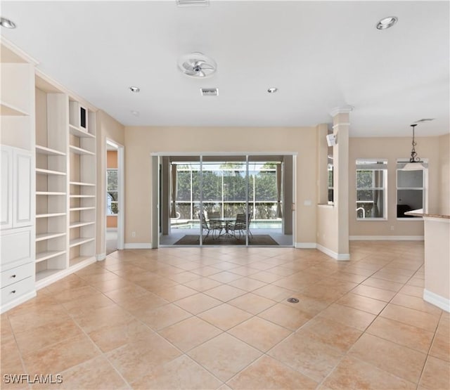 17091 Laurelin Ct, North Fort Myers, FL 33917 - unfurnished room with light tile patterned floors, plenty of natural light, built in shelves, and recessed lighting
