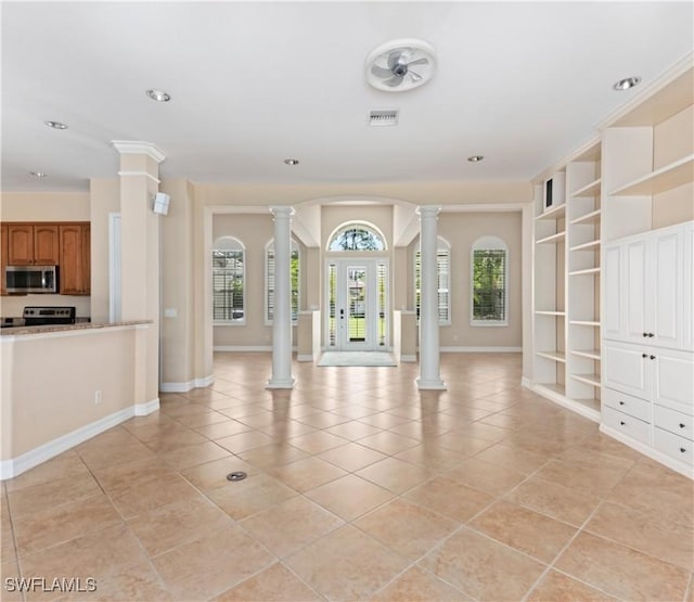 17091 Laurelin Ct, North Fort Myers, FL 33917 - unfurnished living room with ornate columns, light tile patterned floors, recessed lighting, and built in features