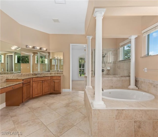 17091 Laurelin Ct, North Fort Myers, FL 33917 - full bath featuring a garden tub, vanity, tiled shower, tile patterned flooring, and decorative columns