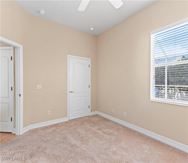 17091 Laurelin Ct, North Fort Myers, FL 33917 - spare room featuring light carpet, ceiling fan, and a smoke detector