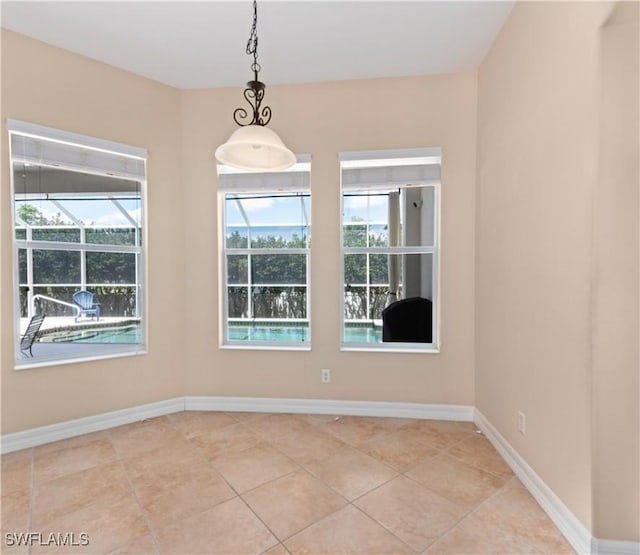 17091 Laurelin Ct, North Fort Myers, FL 33917 - unfurnished dining area with baseboards and light tile patterned flooring