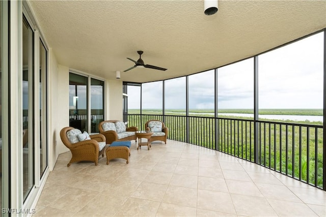 1050 Borghese Ln Unit 605, Naples, FL 34114 - sunroom featuring a ceiling fan and a water view