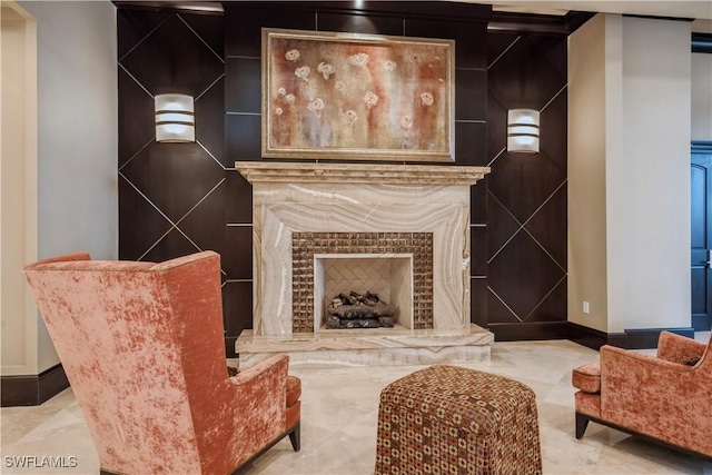 1050 Borghese Ln Unit 605, Naples, FL 34114 - living area with baseboards and a tiled fireplace