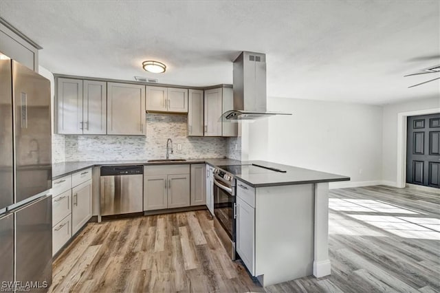 152 Prospect Ave, Fort Myers, FL 33905 - kitchen with appliances with stainless steel finishes, island range hood, dark countertops, a peninsula, and a textured ceiling