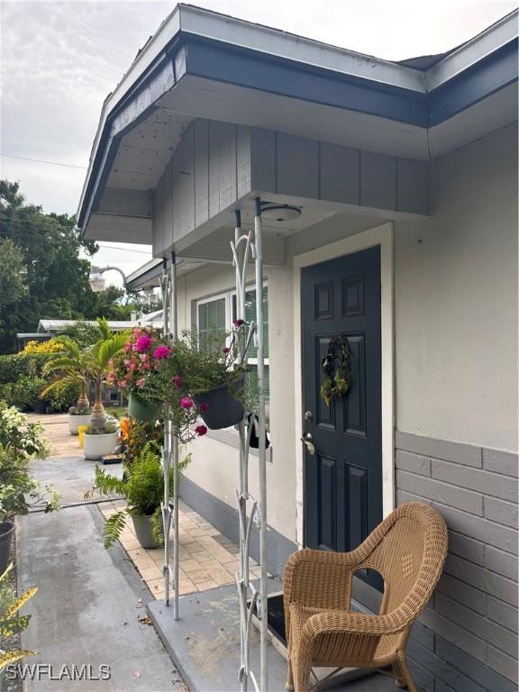 152 Prospect Ave, Fort Myers, FL 33905 - property entrance featuring stucco siding and a patio