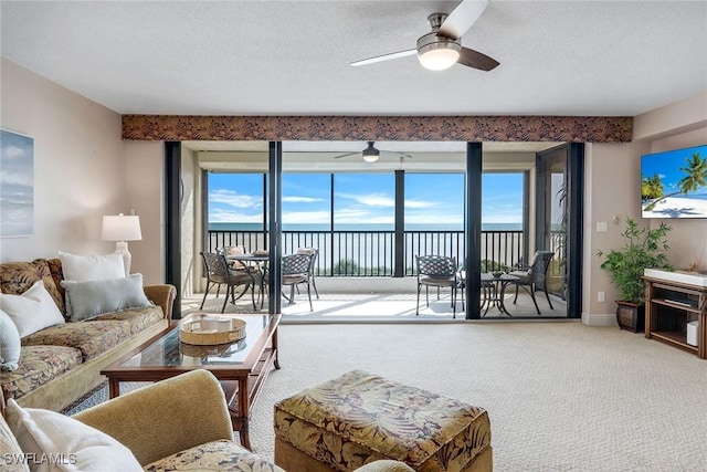 100 N Collier Blvd Unit 303, Marco Island, FL 34145 - living room featuring carpet flooring, a ceiling fan, and healthy amount of natural light