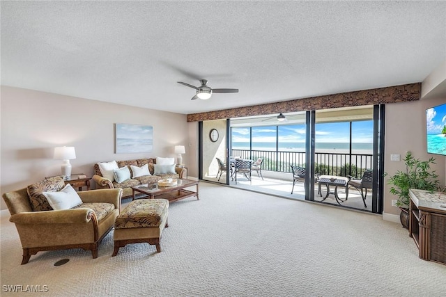 100 N Collier Blvd Unit 303, Marco Island, FL 34145 - living area with carpet floors, ceiling fan, a textured ceiling, baseboards, and a water view