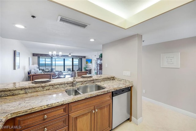 100 N Collier Blvd Unit 303, Marco Island, FL 34145 - kitchen with stainless steel dishwasher, a sink, brown cabinetry, light stone countertops, and a chandelier