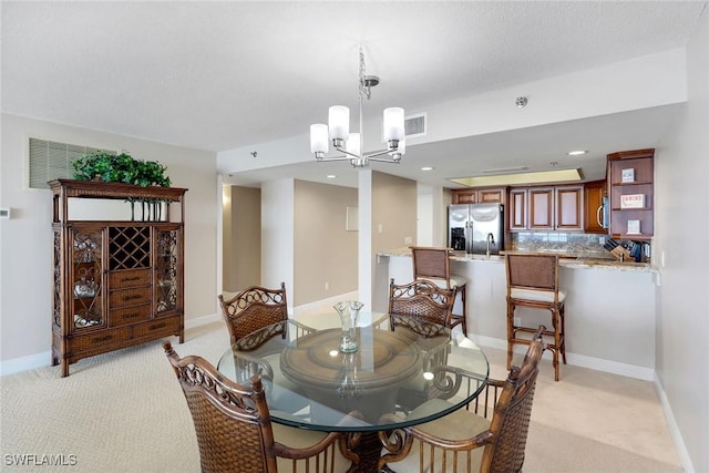 100 N Collier Blvd Unit 303, Marco Island, FL 34145 - dining space featuring a chandelier, light carpet, baseboards, and recessed lighting