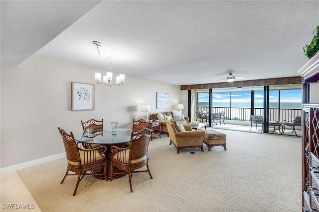 100 N Collier Blvd Unit 303, Marco Island, FL 34145 - carpeted dining space featuring a chandelier, a ceiling fan, a textured ceiling, and baseboards