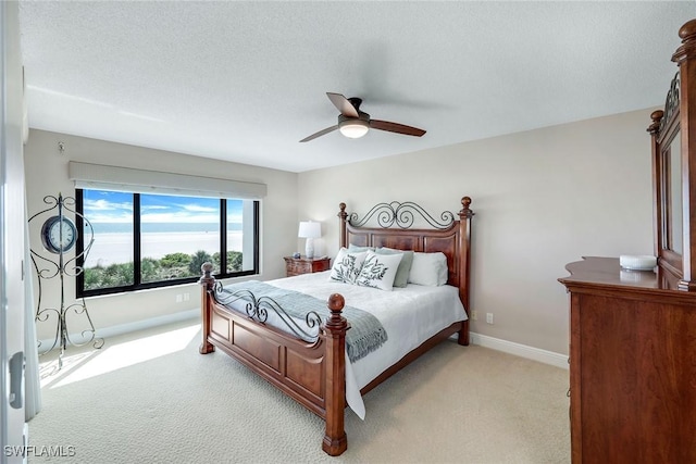100 N Collier Blvd Unit 303, Marco Island, FL 34145 - bedroom with light colored carpet, baseboards, and ceiling fan