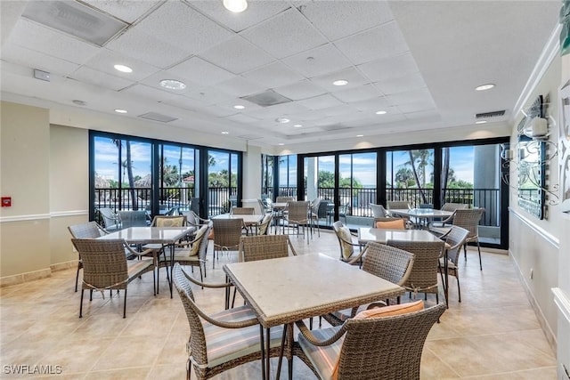 100 N Collier Blvd Unit 303, Marco Island, FL 34145 - dining space featuring light tile patterned flooring, baseboards, and a paneled ceiling