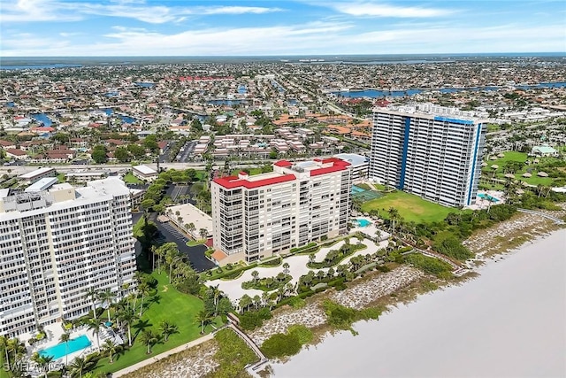 100 N Collier Blvd Unit 303, Marco Island, FL 34145 - drone / aerial view of a nearby body of water, a pool, and apartment complex