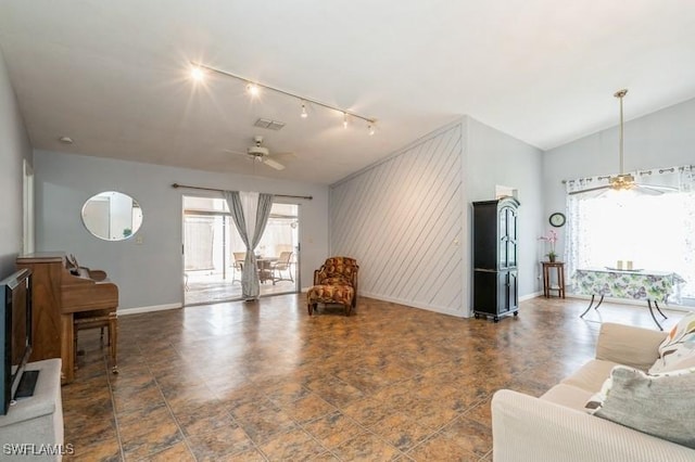 9749 Maplecrest Cir, Lehigh Acres, FL 33936 - living room featuring ceiling fan, track lighting, baseboards, and vaulted ceiling