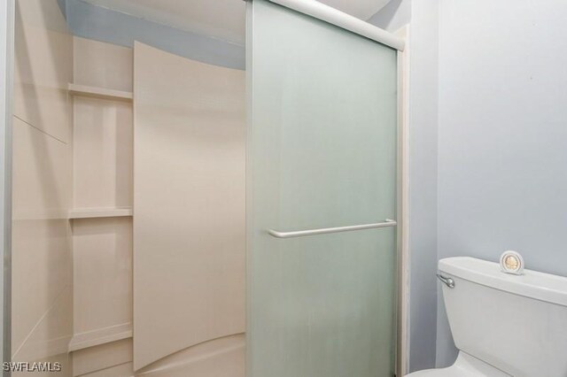 9749 Maplecrest Cir, Lehigh Acres, FL 33936 - bathroom featuring a shower stall and toilet