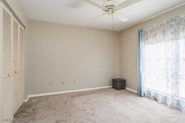 9749 Maplecrest Cir, Lehigh Acres, FL 33936 - unfurnished bedroom featuring carpet flooring, baseboards, a closet, and ceiling fan