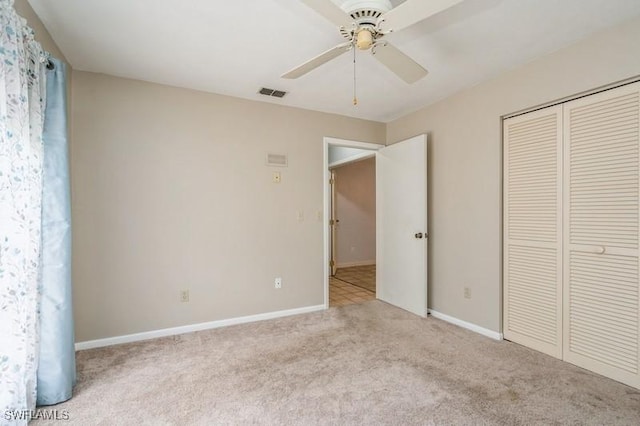 9749 Maplecrest Cir, Lehigh Acres, FL 33936 - unfurnished bedroom with carpet floors, a closet, baseboards, and a ceiling fan