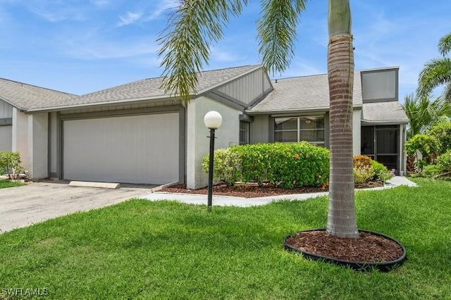 9749 Maplecrest Cir, Lehigh Acres, FL 33936 - single story home featuring concrete driveway, an attached garage, a front yard, and roof with shingles