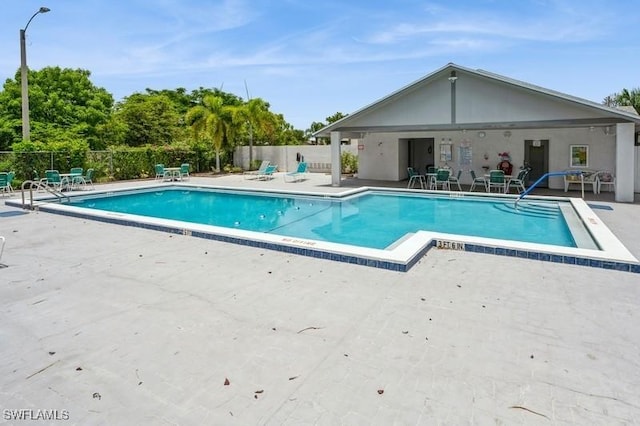 9749 Maplecrest Cir, Lehigh Acres, FL 33936 - community pool featuring a patio