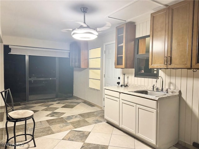 1110 Rushmore Ave N, Lehigh Acres, FL 33936 - kitchen featuring light countertops, glass insert cabinets, and light tile patterned floors