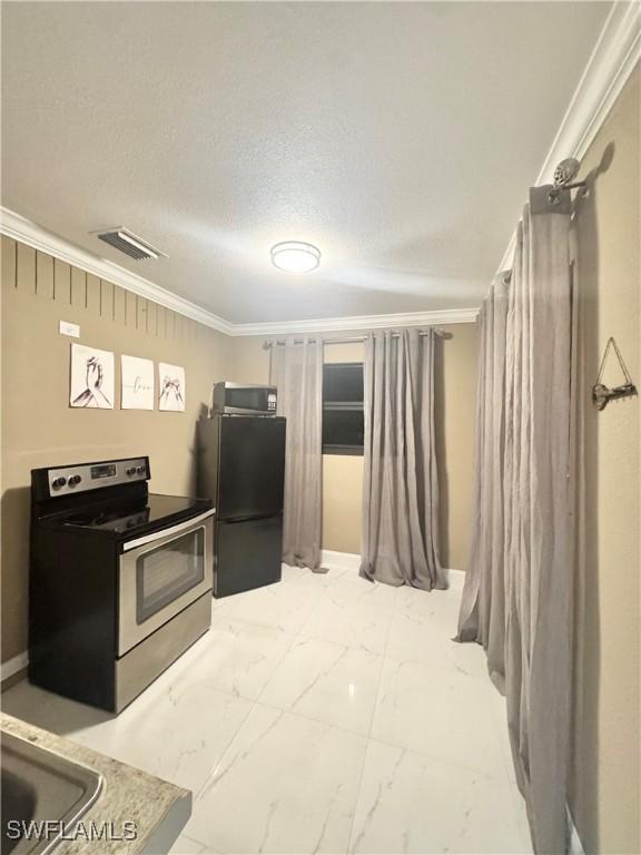 1110 Rushmore Ave N, Lehigh Acres, FL 33936 - kitchen with appliances with stainless steel finishes, ornamental molding, and light marble finish flooring