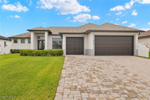 3318 NW 1st Ter, Cape Coral, FL 33993 - prairie-style home featuring a garage, decorative driveway, stucco siding, french doors, and a shingled roof
