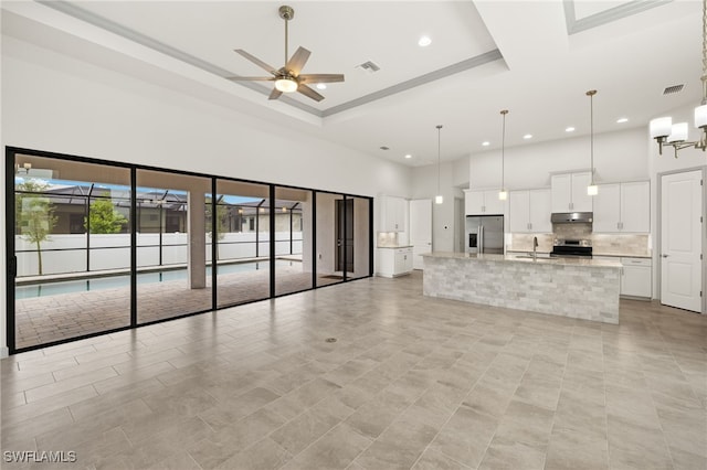 3318 NW 1st Ter, Cape Coral, FL 33993 - unfurnished living room featuring a high ceiling, a ceiling fan, recessed lighting, and light tile patterned floors