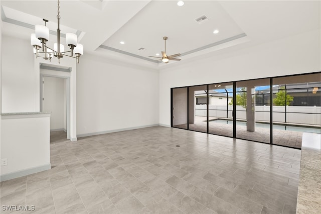 3318 NW 1st Ter, Cape Coral, FL 33993 - empty room with a raised ceiling, ceiling fan, a chandelier, recessed lighting, and a high ceiling