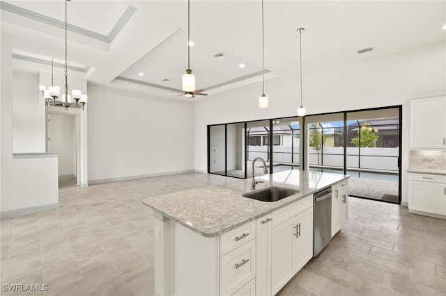 3318 NW 1st Ter, Cape Coral, FL 33993 - kitchen featuring dishwasher, an island with sink, white cabinets, a tray ceiling, and light stone countertops