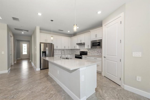 16176 Rosemallow Ln, Alva, FL 33920 - kitchen featuring appliances with stainless steel finishes, under cabinet range hood, white cabinets, decorative backsplash, and light countertops