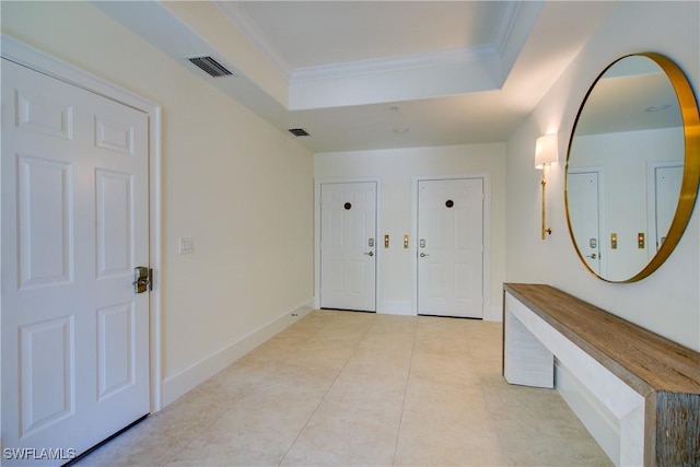 2855 Tiburon Blvd E Unit 102, Naples, FL 34109 - entryway with a tray ceiling, ornamental molding, and light tile patterned floors