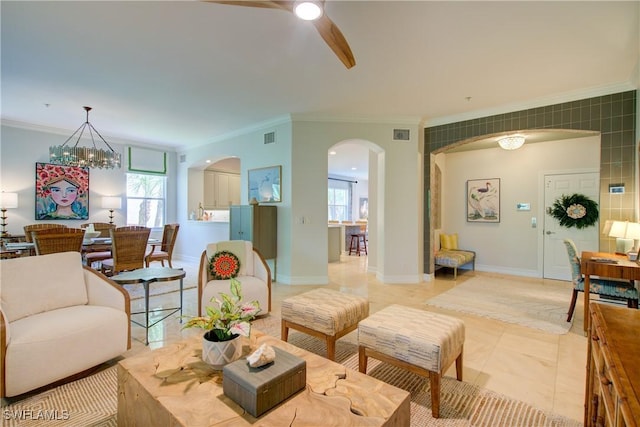 2855 Tiburon Blvd E Unit 102, Naples, FL 34109 - living area with arched walkways, ornamental molding, a chandelier, ceiling fan, and light tile patterned floors