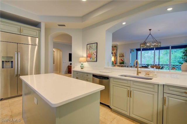 2855 Tiburon Blvd E Unit 102, Naples, FL 34109 - kitchen with appliances with stainless steel finishes, light countertops, light tile patterned flooring, arched walkways, and recessed lighting