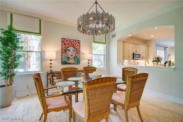 2855 Tiburon Blvd E Unit 102, Naples, FL 34109 - dining area featuring plenty of natural light, arched walkways, crown molding, a chandelier, and light tile patterned flooring