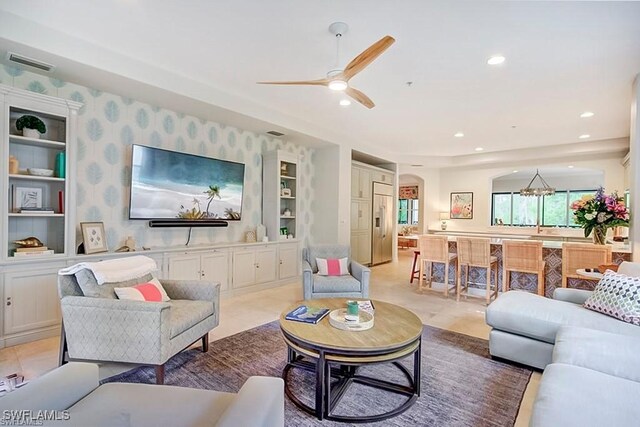 2855 Tiburon Blvd E Unit 102, Naples, FL 34109 - living room with a ceiling fan, recessed lighting, a chandelier, arched walkways, and wallpapered walls