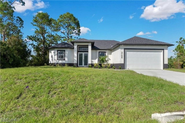 3108 22nd St SW, Lehigh Acres, FL 33976 - prairie-style house with french doors, stucco siding, an attached garage, a front yard, and driveway