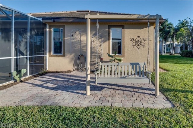 14266 Reflection Lakes Dr, Fort Myers, FL 33907 - rear view of house with stucco siding, a lawn, and a patio area