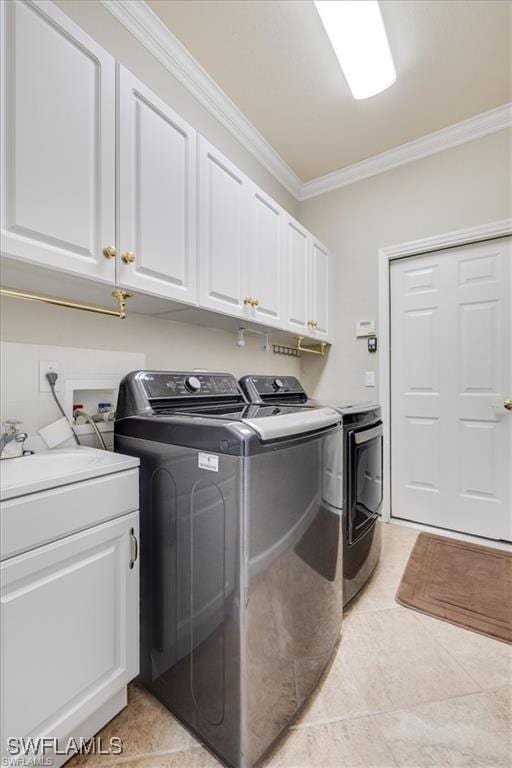 14266 Reflection Lakes Dr, Fort Myers, FL 33907 - laundry room featuring separate washer and dryer, crown molding, cabinet space, and light tile patterned flooring
