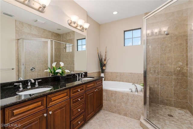 9051 Capistrano St N Unit 4302, Naples, FL 34113 - full bathroom with a stall shower, double vanity, a garden tub, and tile patterned floors