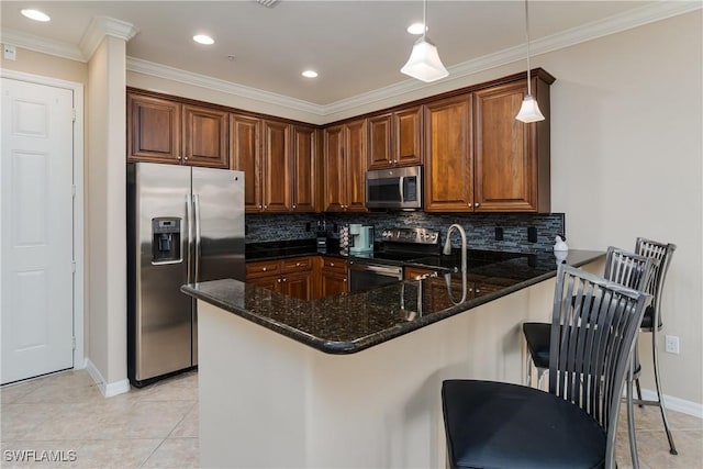 9051 Capistrano St N Unit 4302, Naples, FL 34113 - kitchen featuring stainless steel appliances, a peninsula, dark stone counters, tasteful backsplash, and ornamental molding