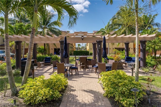 9051 Capistrano St N Unit 4302, Naples, FL 34113 - view of community with a pergola, outdoor lounge area, and a patio area