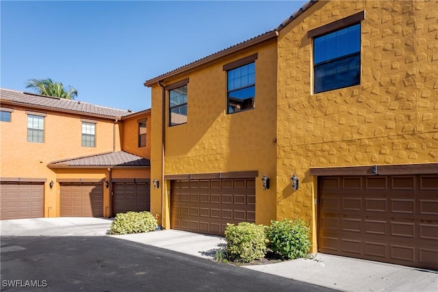 9051 Capistrano St N Unit 4302, Naples, FL 34113 - mediterranean / spanish home featuring a garage and stucco siding
