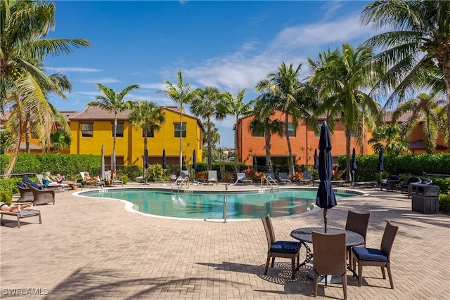 9051 Capistrano St N Unit 4302, Naples, FL 34113 - community pool featuring a patio