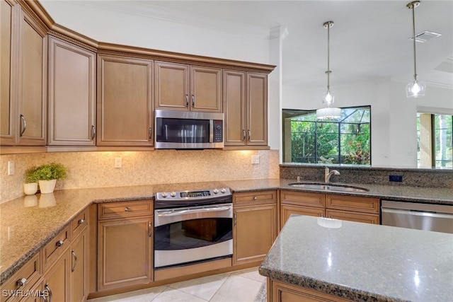 7327 Acorn Way, Naples, FL 34119 - kitchen featuring appliances with stainless steel finishes, a sink, stone counters, and hanging light fixtures