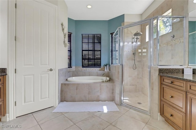7327 Acorn Way, Naples, FL 34119 - bathroom featuring tile patterned floors, vanity, a garden tub, and a shower stall
