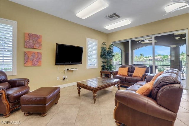 7327 Acorn Way, Naples, FL 34119 - living room featuring a ceiling fan, light tile patterned floors, and healthy amount of natural light