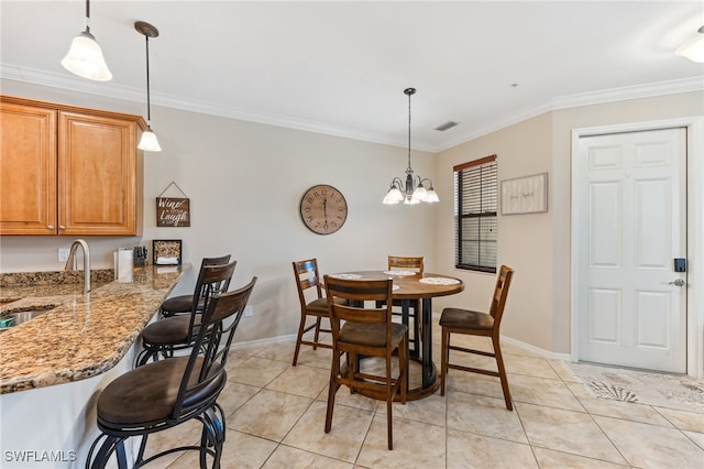 9063 Capistrano St N Unit 4401, Naples, FL 34113 - dining room featuring light tile patterned flooring, ornamental molding, and a chandelier
