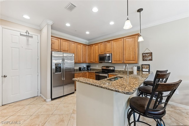 9063 Capistrano St N Unit 4401, Naples, FL 34113 - kitchen featuring appliances with stainless steel finishes, a peninsula, brown cabinets, stone counters, and crown molding