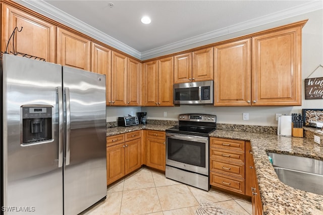 9063 Capistrano St N Unit 4401, Naples, FL 34113 - kitchen featuring appliances with stainless steel finishes, light tile patterned floors, ornamental molding, brown cabinetry, and stone counters