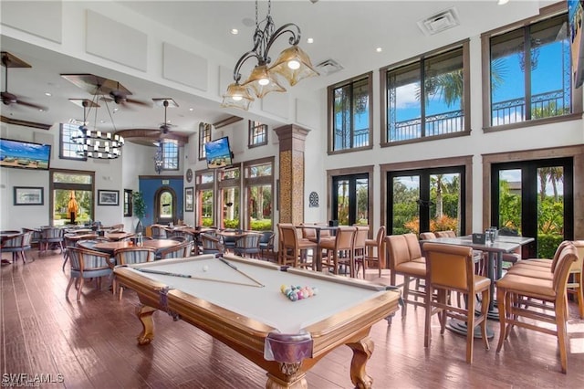 9063 Capistrano St N Unit 4401, Naples, FL 34113 - game room with a towering ceiling, billiards, ceiling fan, french doors, and wood-type flooring